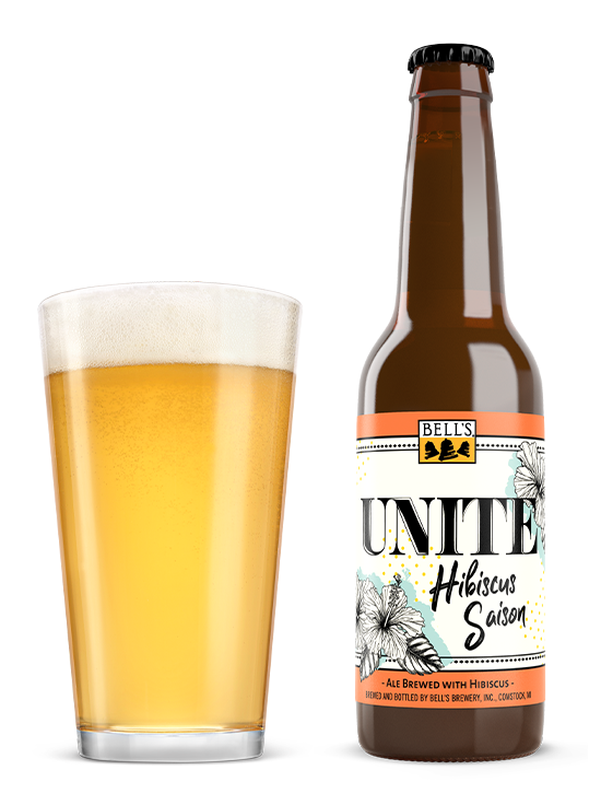 A pint next to a bottle of Unite Hibiscus Saison.